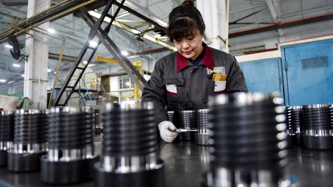 En medarbejder tjekker dele på en fabrik i byen Zhangjiakou i den nordlige kinesiske provins Hebei. Ifølge en ny rapport er Kina på vej til at overhale USA som verdens største økonomi fem år før tid. (Arkivfoto)